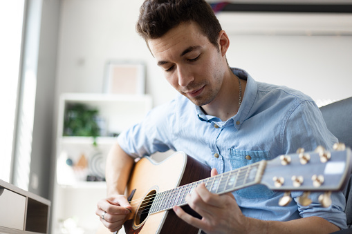 Young man playing acoustic guitar