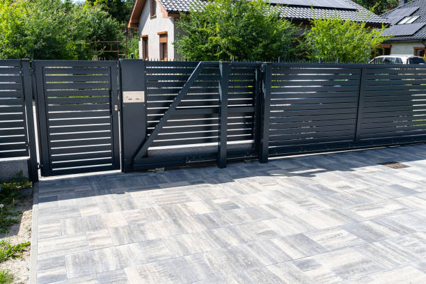 a modern panel fence in anthracite color, a visible sliding gate to the garage and a wicket with a letterbox. - wicket imagens e fotografias de stock