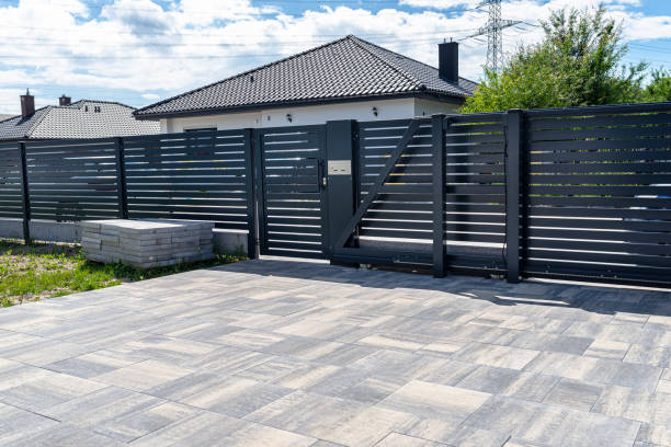 istock A modern panel fence in anthracite color, a visible sliding gate to the garage and a wicket with a letterbox. 1411398153