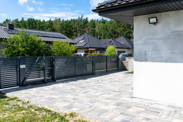 istock A modern panel fence in anthracite color, a visible sliding gate to the garage and a wicket with a letterbox. 1411398172