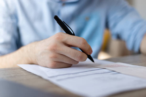 istock Businessman sitting at office desk signing a contract. 1411399667