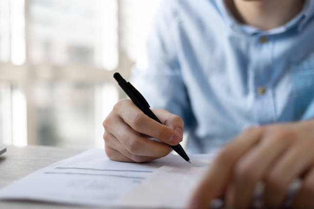 istock Businessman sitting at office desk signing a contract. 1411399668