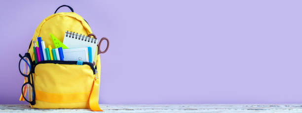 istock Banner. Concept back to school. Full tyelllow School Backpack with stationery on table. 1411400578