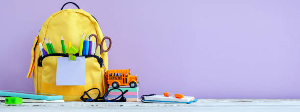 istock Banner. Concept back to school. Full tyelllow School Backpack with stationery on table. 1411400590