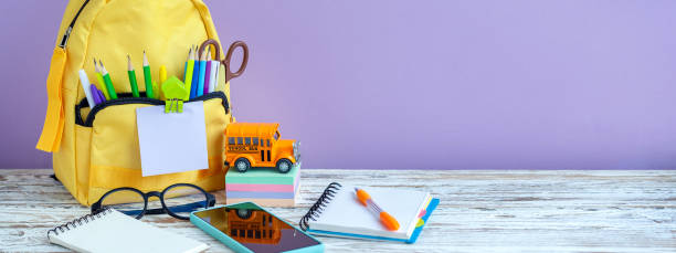 istock Banner. Concept back to school. Full tyelllow School Backpack with stationery on table. 1411400606