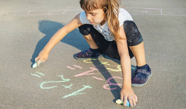 istock Cute Girl Writing On Road 1411402101