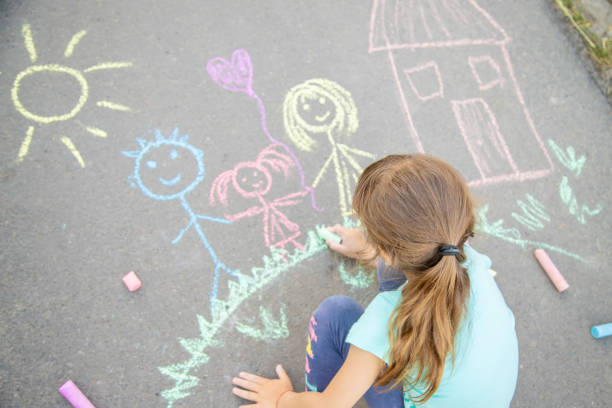 istock Girl Drawing On Road 1411402137