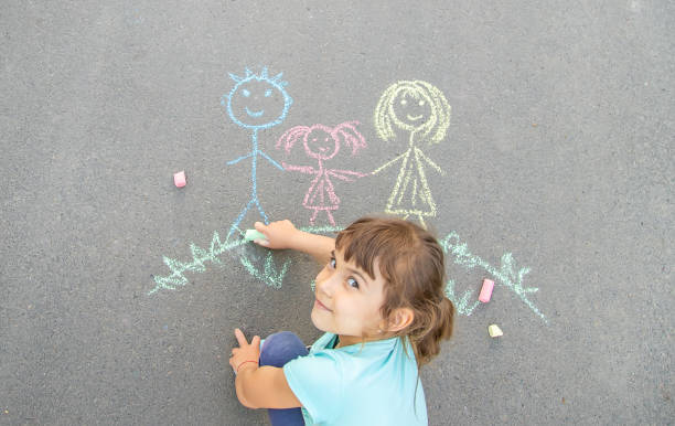 istock Girl Drawing On Road 1411402138