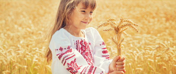 istock Cute Girl With Wheat Standing At Farm 1411402308