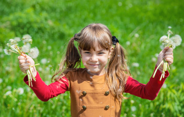 istock Young Woman With Arms Raised Standing Against Tree 1411402516