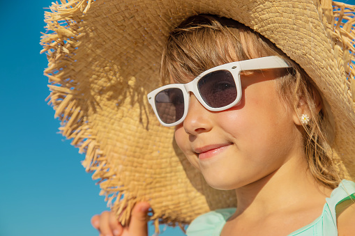 Cute girl with a sunglasses on the beach.