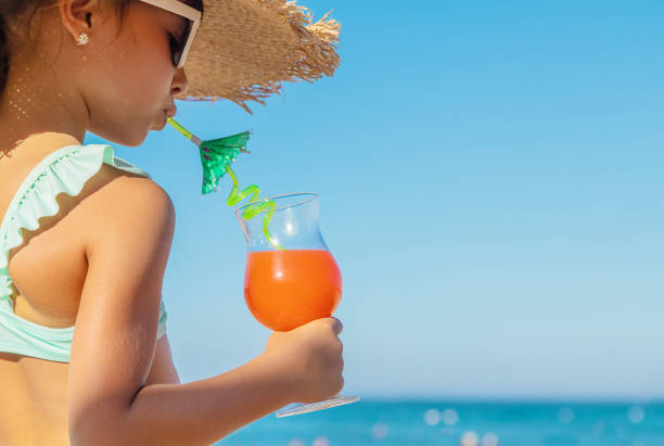 istock Young Woman Holding Drink 1411402790