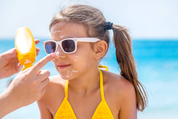 istock Mother Applying Suntan Lotion On Daughters Face 1411403578