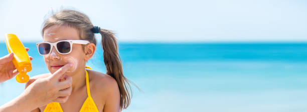 istock Mother Applying Suntan Lotion On Daughters Face 1411403586