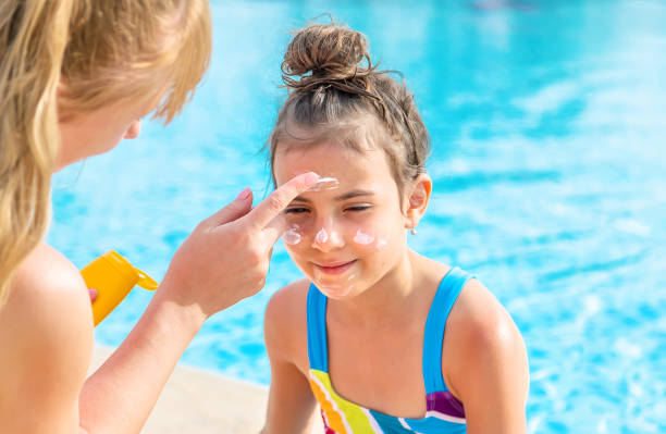 istock Mother Applying Suntan Lotion On Daughters Face 1411403597