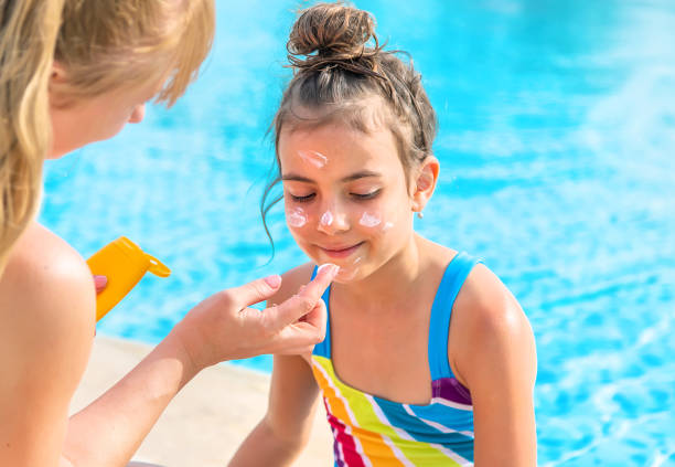 istock Mother Applying Suntan Lotion On Daughters Face 1411403601