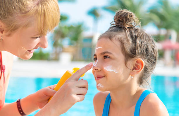 istock Mother Applying Suntan Lotion On Daughters Face 1411403622