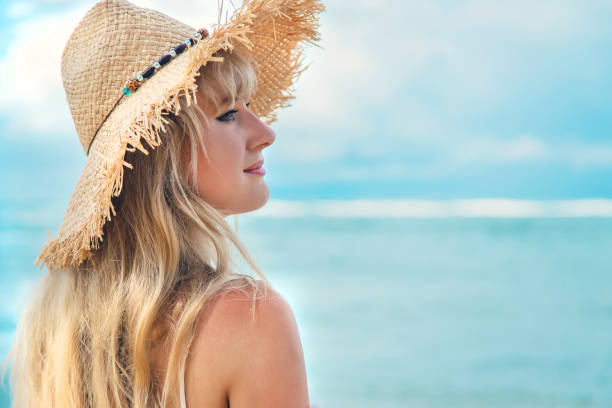 istock Woman Wearing Straw Hat At Beach 1411403959