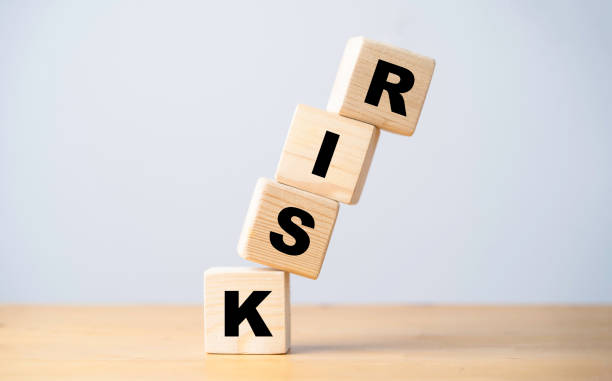 istock Risk wording print screen on wooden cube block and falling on the table for risk analysis and management concept. 1411404385