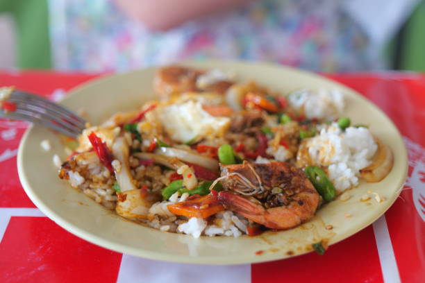 Spicy Thai rice dish with shrimps served on a white plate