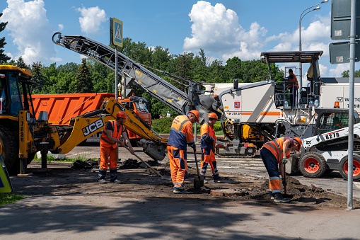 Moscow, Russia - 06.14.2021: Moscow city road repair site, workers are laying new asphalt