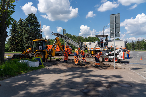 Moscow, Russia - 06.14.2021: Moscow city road repair site, workers are laying new asphalt