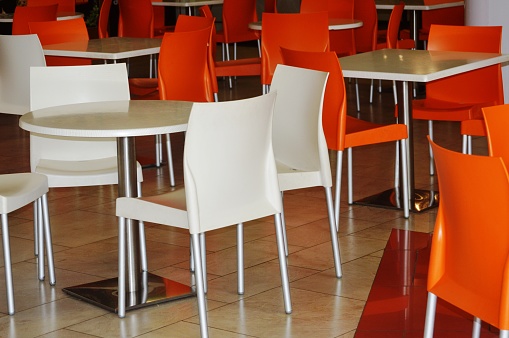 multicolored plastic tables and chairs in a summer cafe