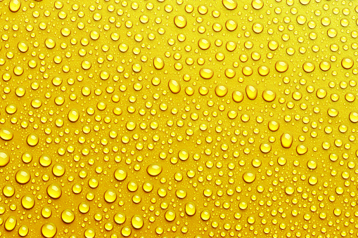 Texture with water drops on yellow background
