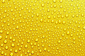 Texture with water drops on yellow background