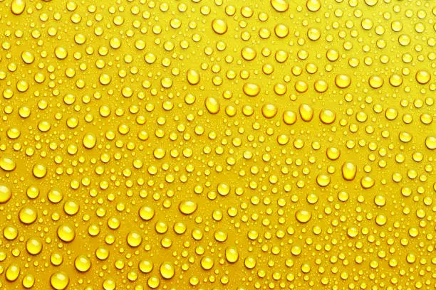 Photo of Texture with water drops on yellow background