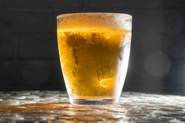 istock cold and misted cup of beer on a dark background with backlighting, multiple fingerprints on the wall 1411408044