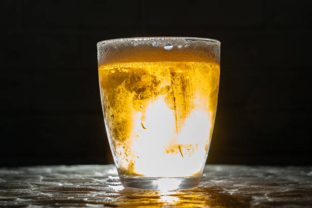 istock cold and misted cup of beer on a dark background with backlighting, multiple fingerprints on the wall 1411408581
