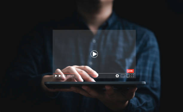 istock Man holding tablet and watching for live streaming for Video streaming on internet and multimedia technology concept. 1411410464