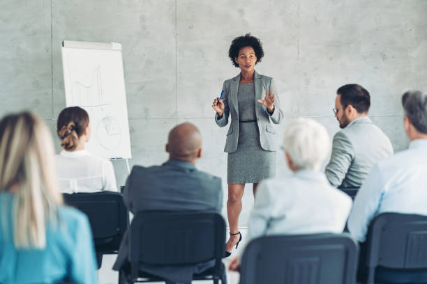 istock Businesswoman talking in front of a group 1411410526