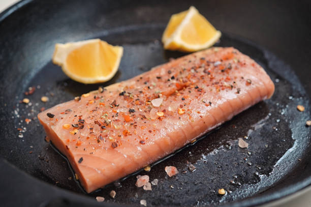 istock Salmon Fillet Steak In A Pan With Lemon Slices 1411410588