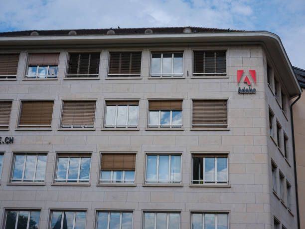 Adobe Logo on side of Building. Basel, Switzerland - July 4 2022: Adobe Logo on side of Building. Adobe Inc. is an American multinational computer software company headquartered in San Jose. adobe material stock pictures, royalty-free photos & images