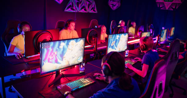 Diverse yellow and blue pro gamer teams with african ethnicity players competing at video game eSport championship. stock photo