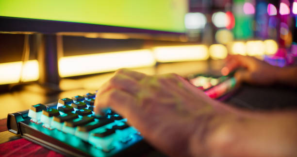 istock Close-up hand on a computer keyboard. Diverse pro gamer team with african ethnicity leader competing at video game eSport championship 1411413387