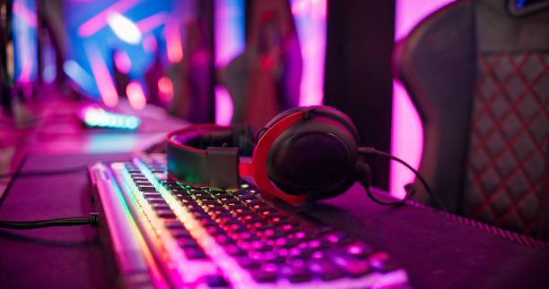 istock Pro gamer team computer setup at video game eSport championship with neon keyboard. Video game on monitor screen 1411413593