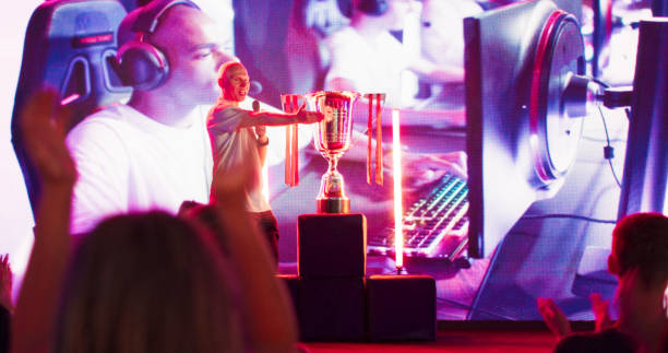 istock Audience watching esport video game championship on a huge display screen. Cheering and clapping for their favorite players. Listening to commentator 1411413690