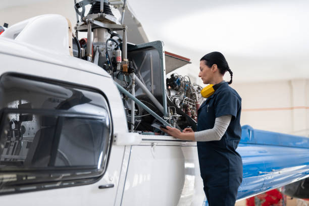 istock Female mechanic checking helicopter 1411417445