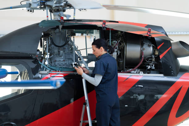 istock Female mechanic fixing helicopter 1411417446