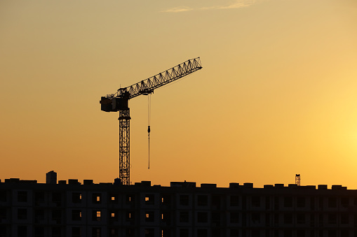 Housing construction, apartment block in city on morning sky background