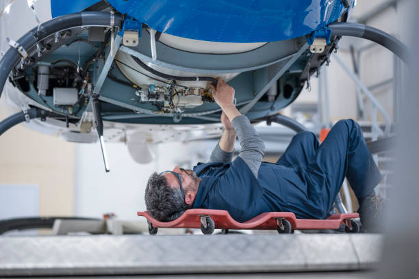 istock Mechanic repairing helicopter engine 1411420050