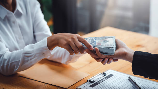 istock Business people giving bribe and collaborating with corruption. Bribery and corruption concept. 1411420108