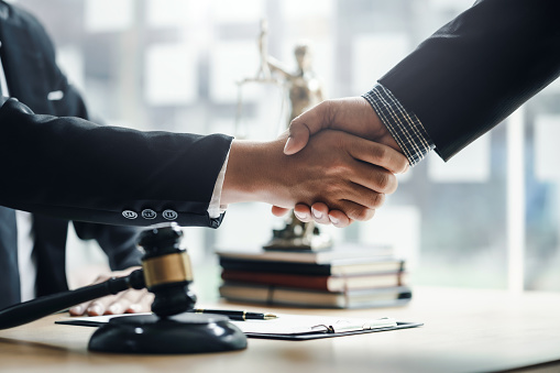 Businessman handshake partner lawyers or attorneys discussing a contract agreement. Business people shaking hands to congratulate success.