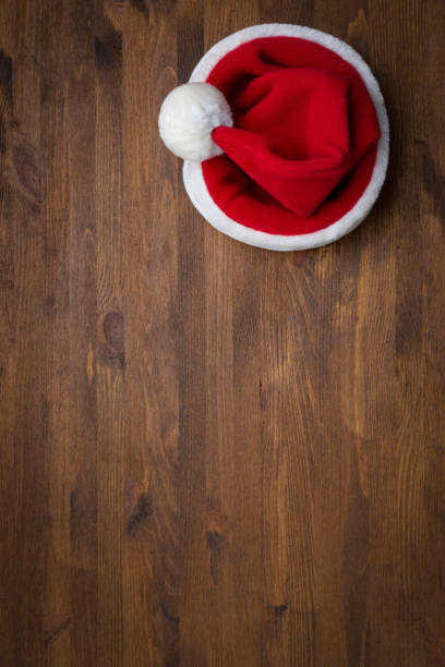 Santa Claus hat on a wooden background. Christmas, New Year