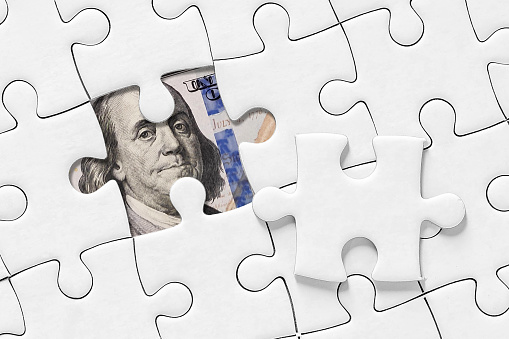 Making money concept. White jigsaw puzzle with dollar. Jigsaw puzzle with missing piece.