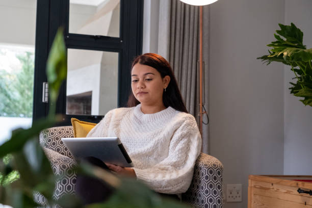 istock Woman works on her tablet at home 1411421647