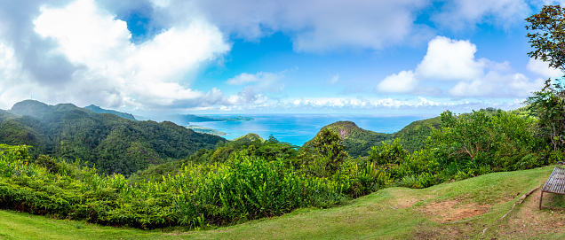 Mahe Island coast panorama seen from Venn's Town - Mission Lodge wooden viewing platform, lush tropical forest with crystal blue Indian Ocean.